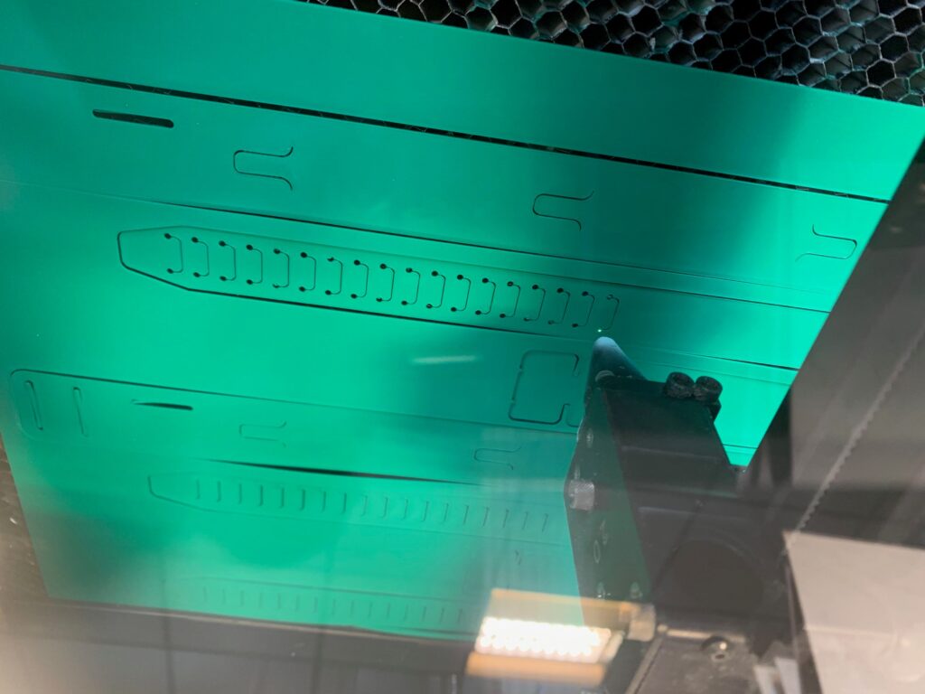 Arthur Terry’s laser cutter making parts for the visors.