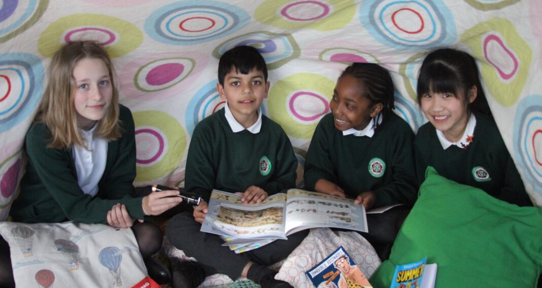 Eleven-year-old Isabel Rutherford, Ralph Sullivan, eight, Tyquse Howe, eight and ten-year-old Jacey Lin try one of the reading challenges.