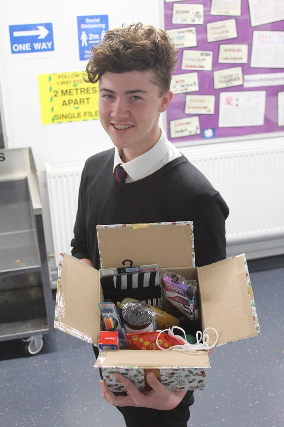 Big-hearted Plantsbrook student Ben Songhurst with one of the Christmas care parcels he is creating.