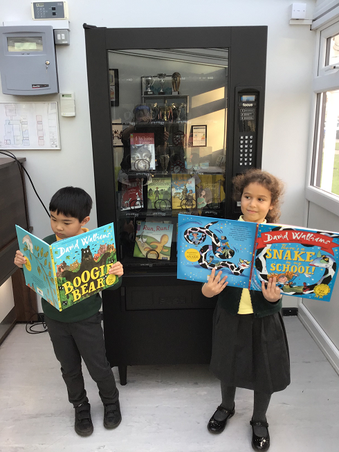 Mere Green pupils Hannah and Louis enjoy some of the books.