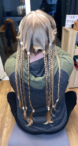 Her long hair was put into plaits before it was cut.