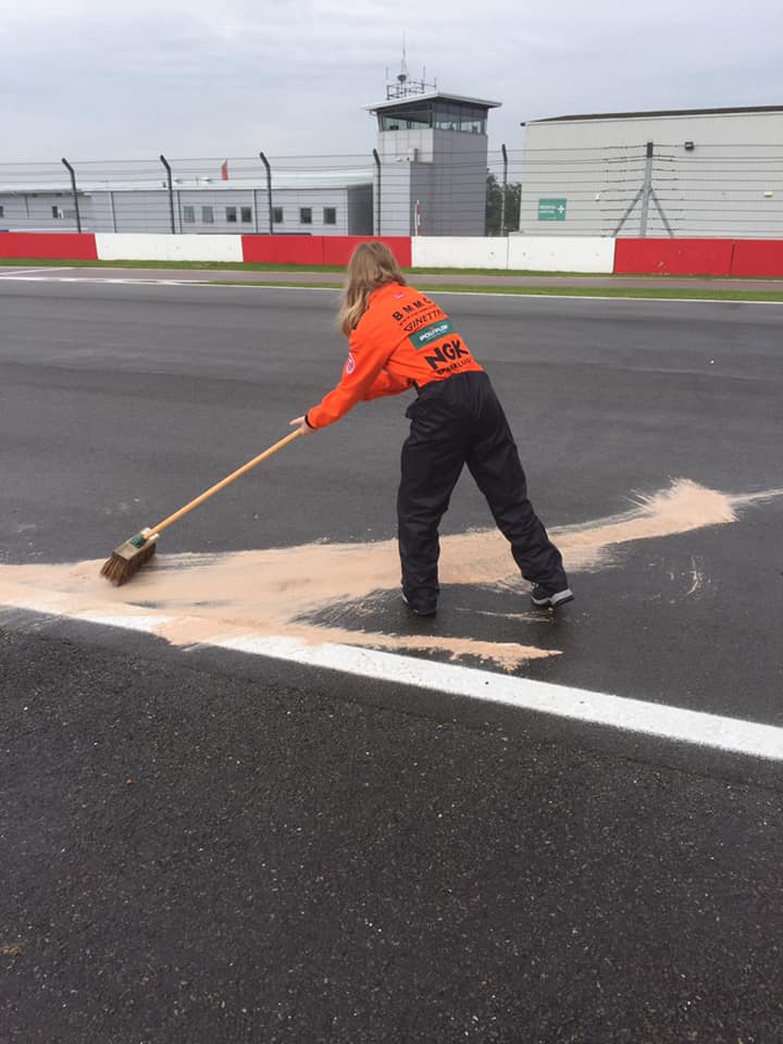 Charlotte in action in the paddock at a major motorsport event.