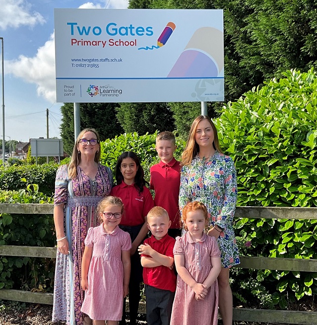 Two Gates Primary School headteacher Nêst Llewelyn-Cook (left), assistant headteacher Sophie Smart and pupils are all smiles following the Ofsted report.
