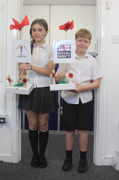 Lilly Sheldon-Armstrong and Brodie Thomas with some of the artworks.