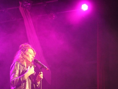 Arthur Terry alumni Jessika on stage at the school.